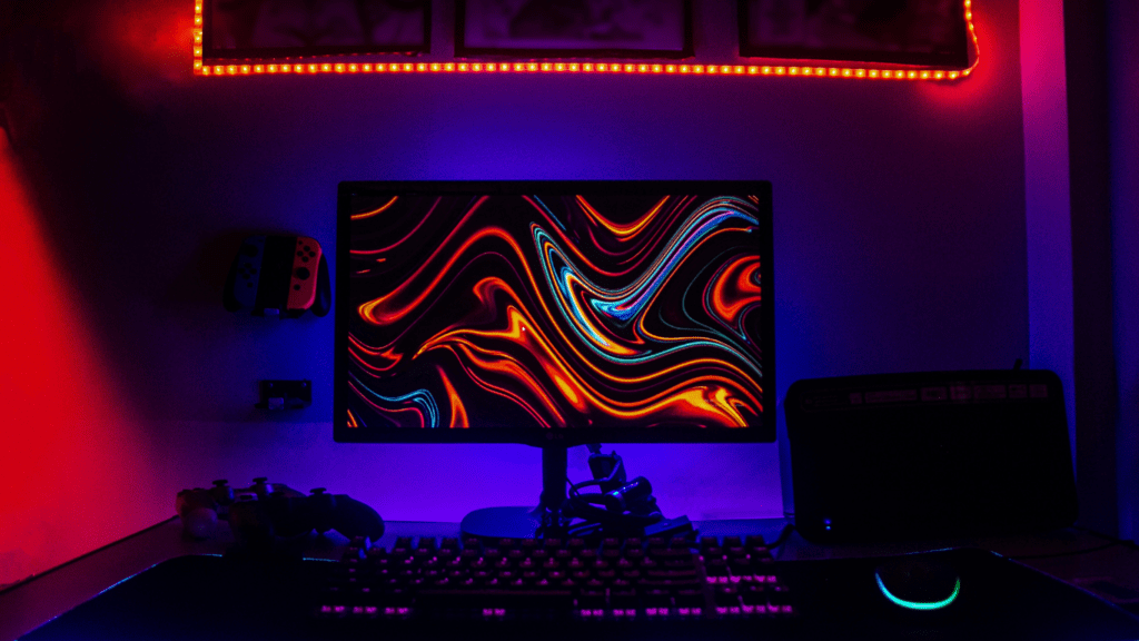 a computer desk lit up with red and blue lights