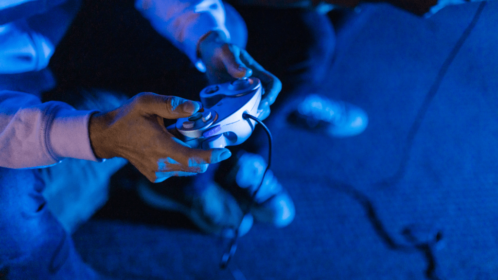 a person holding a gaming controller