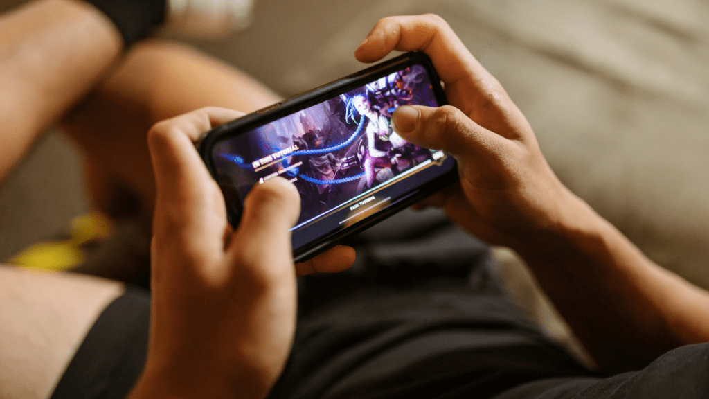 a person playing mobile games