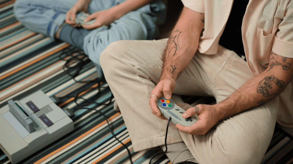 a person sitting on the floor playing video games