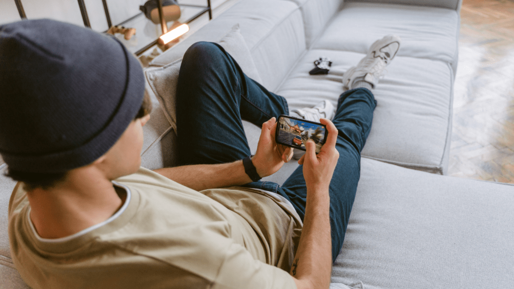 a person sitting on a couch playing a video game