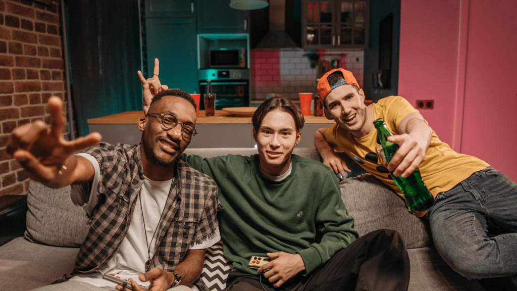 young men sitting on a couch in a living room