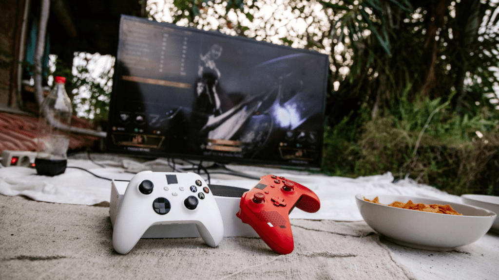 two red and white video game controllers sitting on a blanket