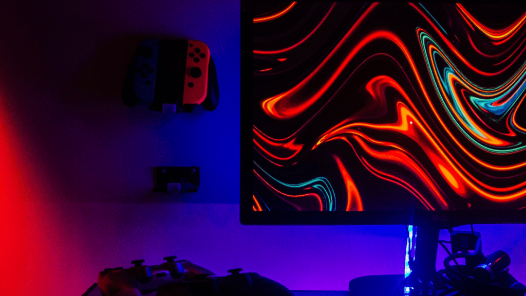 a computer desk lit up with red and blue lights