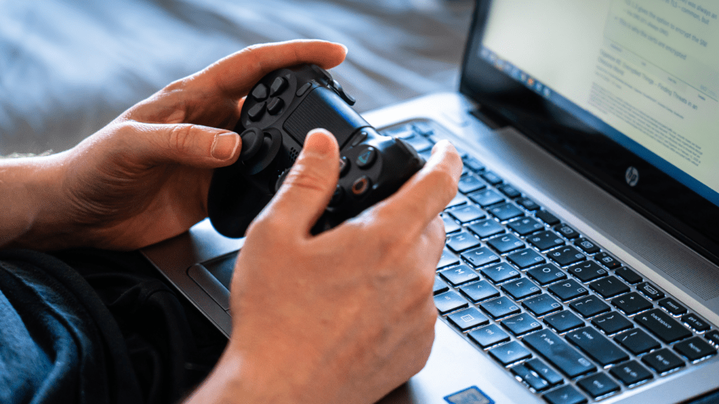 a person holding a video game controller in front of a television