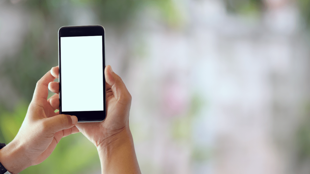 a person is using a smartphone with a blank white screen