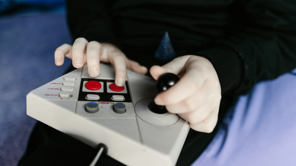 a person sitting on the floor playing video games