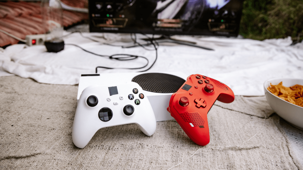 two red and white video game controllers sitting on a blanket