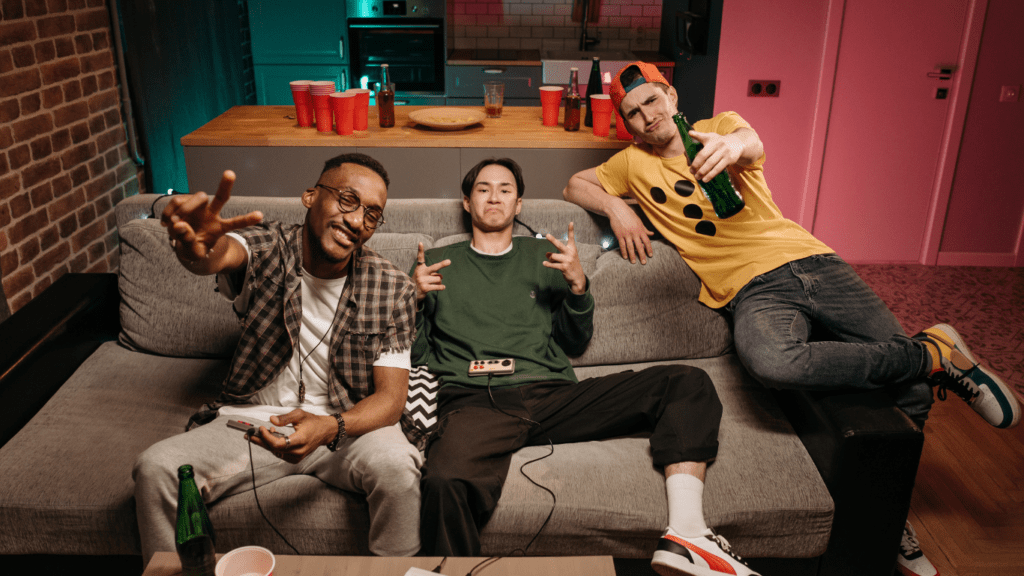 young men sitting on a couch in a living room